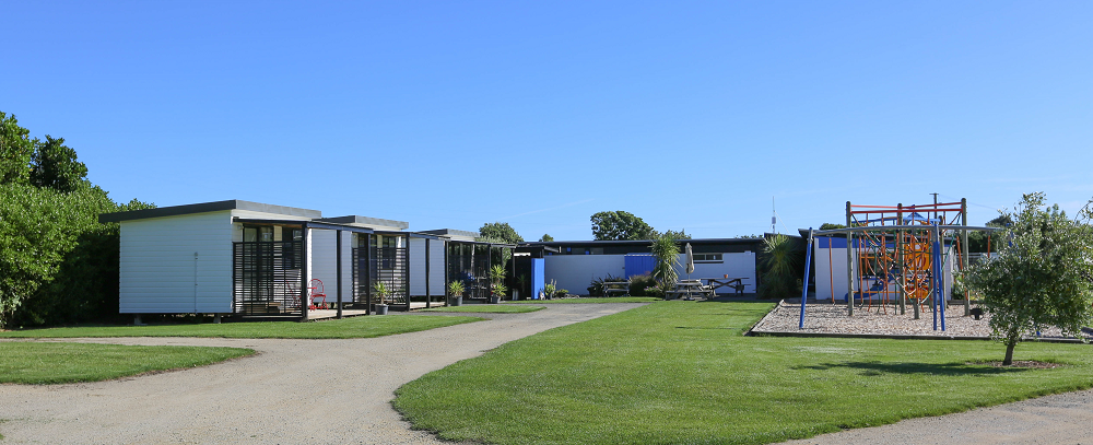 Cottages and playground at Kai Iwi Beach Holiday Park