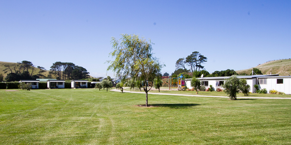Aerial view of Kai Iwi Beach Holiday Park looking out to the Tasman Sea